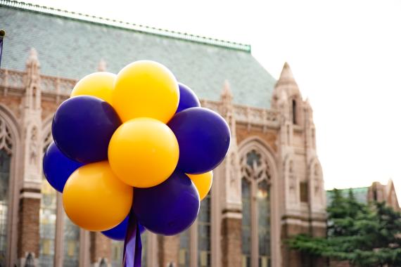 Gold and purple balloons in front of Suzzallo Library