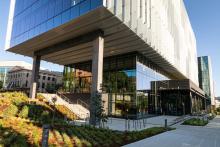 The exterior of the Hans Rosling Population Health Building, a modern and architecturally striking facility with sleek lines and large windows, surrounded by landscaped green spaces.