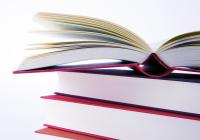 Stack of three red books. The top book is open. White background. 