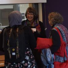 Department Chair Sasha Welland conversing with two Fall Reception attendees.